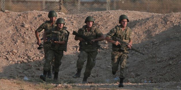 Turkish soldiers run to their new positions at the Syria border in Akcakale, southeastern Turkey, Monday, June 15, 2015. Kurdish fighters with the Kurdish People's Protection Units, or YPG, captured large parts of the strategic border town of Tal Abyad from the Islamic State group Monday, dealing a huge blow to the group which lost a key supply line for its nearby de facto capital of Raqqa, a spokesman for the main Kurdish fighting force said. (AP Photo/Lefteris Pitarakis)