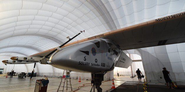 Ground crew work inside the mobile hanger of the solar-powered airplane Solar Impulse 2 at Nagoya airport in Nagoya on June 3, 2015. The record-breaking Solar Impulse 2 landed safely in Nagoya, Japan late on June 1 on an unscheduled stop caused by bad weather over the Pacific.     AFP PHOTO / TOSHIFUMI KITAMURA        (Photo credit should read TOSHIFUMI KITAMURA/AFP/Getty Images)