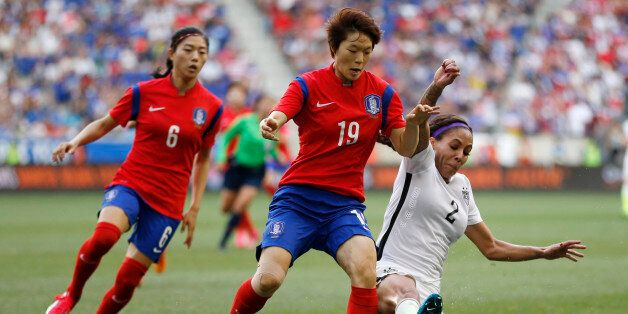 United States forward Sydney Leroux, right, slides for the ball as South Korea defender Kim Doyeon, center, and Shim Seoyeon, left, defend during the second half of an international friendly soccer match, Saturday, May 30, 2015, in Harrison, N.J. The teams tied 0-0. (AP Photo/Julio Cortez)