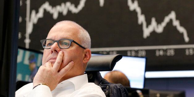 A broker sits under he curve of the German stock index DAX at the stock market in Frankfurt, Germany, Friday, June 19, 2015. (AP Photo/Michael Probst)