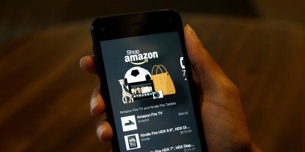 FILE - This June 18, 2014, file photo shows the app that links to shopping on Amazon.com on the new Amazon Fire Phone, in Seattle. The best tool for saving money while holiday shopping can be a smartphone packed with the right apps. (AP Photo/Ted S. Warren, File)