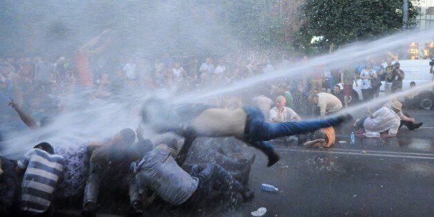 Armenian police use water canons to disperse protesters demonstrating an increase in electricity prices in the Armenian capital of Yerevan, Tuesday, June 23, 2015. Several thousand demonstrators marched toward the presidential residence in the Armenian capital on Tuesday to protest a hike in electricity prices, renewing their demonstration in even greater numbers after riot police used water cannons to forcefully disperse them earlier in the day. (Narek Aleksanyan/PAN Photo via AP)