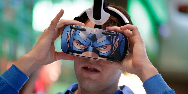 A brand ambassador tests Samsung's Gear VR headset at the Samsung Galaxy booth at the International CES Tuesday, Jan. 6, 2015, in Las Vegas. (AP Photo/Jae C. Hong)