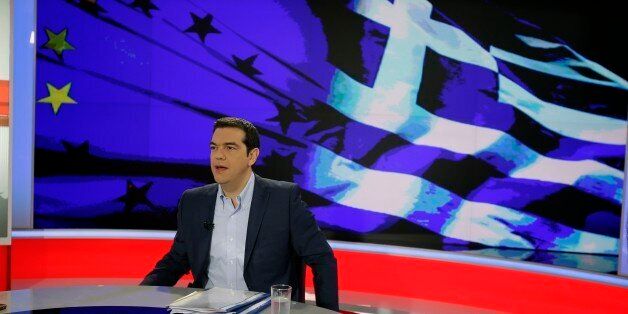 Greece's Prime Minister Alexis Tsipras prepares for a TV interview at the State Television (ERT) in Athens, Monday, June 29, 2015. Anxious pensioners swarmed closed bank branches Monday and long lines snaked at ATMs as Greeks endured the first day of serious controls on their daily economic lives ahead of a July 5 referendum that could determine whether the country has to ditch the euro currency and return to the drachma. (AP Photo/Thanassis Stavrakis)