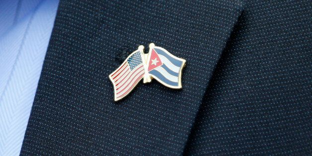 A member of the U.S. Senate delegation wears a crossed flag pin representing the US and Cuban national flags, at a press conference in Havana, Cuba, Saturday, June 27, 2015.  The U.S. Senate bipartisan delegation spoke to the media during their visit to Cuba as the two countries move toward reopening embassies and restoring long-strained diplomatic ties. (AP Photo/Desmond Boylan)