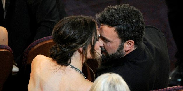 Jennifer Garner, left, kisses director Ben Affleck after