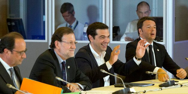 Greek Prime Minister Alexis Tsipras, second left, gestures while speaking during a round table meeting at an emergency summit of eurozone heads of state or government at the EU Council building in Brussels on Tuesday, July 7, 2015. Greek Prime Minister Alexis Tsipras on Tuesday will try to use a resounding referendum victory to eke out concessions from European creditors over a bailout for the crisis-ridden country. From left, French President Francois Hollande, Spanish Prime Minister Mariano Ra