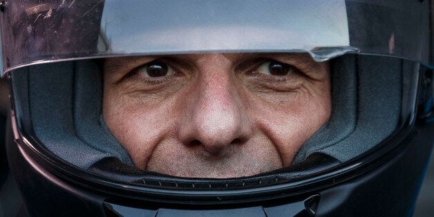 Greece's Finance Minister Yanis Varoufakis puts on his motorbike helmet as he leaves his office in Athens, Wednesday, July 1, 2015. About 1,000 bank branches around the country were ordered by the government to reopen Wednesday to help desperate pensioners without ATM cards cash up to 120 euros ($134) from their retirement checks. Eurozone finance ministers were set to weigh Greece's latest proposal for aid Wednesday. (AP Photo/Daniel Ochoa de Olza)