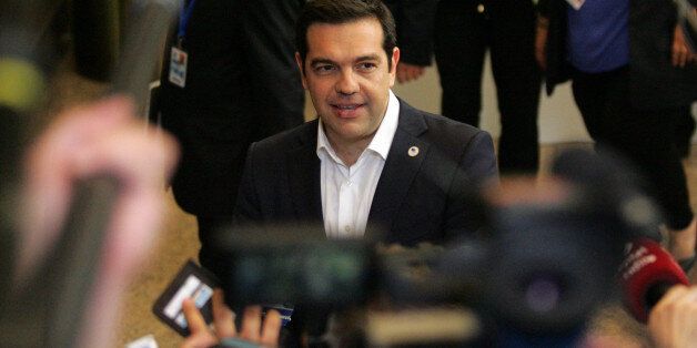 Greek Prime Minister Alexis Tsipras, center, speaks with the media after an emergency summit of eurozone heads of state and government in Brussels on Tuesday, July 7, 2015. Frustrated and angered eurozone leaders gave Greek Prime Minister Alexis Tsipras a last-minute chance on Tuesday to finally come up with a viable proposal on how to save his country from financial ruin. (AP Photo/Francois Walschaerts)