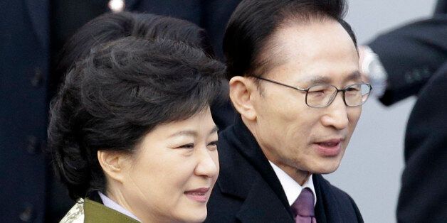 FILE - In this Feb. 25, 2013 file photo, South Korea's outgoing President Lee Myung-bak, right, walks with new President Park Geun-hye after Park's inauguration ceremony as the 18th South Korean president at the National Assembly in Seoul, South Korea. Late North Korean leader Kim Jong Il repeatedly pushed for summit talks with South Korea before his 2011 death but the plans failed because Pyongyang demanded $10 billion and large-scale shipments of food and fertilizer, Lee said in a memoir to be