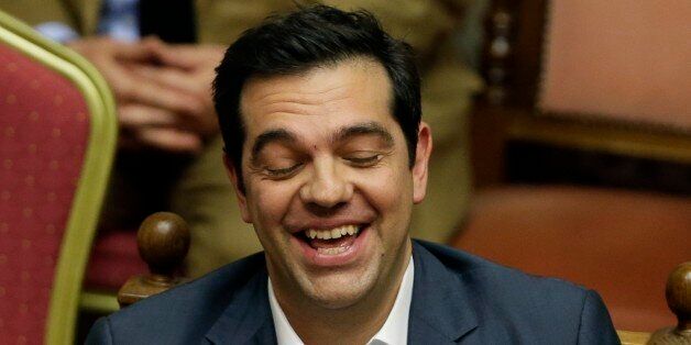 Greece's Prime Minister Alexis Tsipras laughs during a parliament meeting in Athens, Thursday, July 16, 2015. Tsipras was fighting to keep his government intact in the face of outrage over an austerity bill that parliament must pass if the country is to start negotiations on a new bailout and avoid financial collapse. (AP Photo/Thanassis Stavrakis)