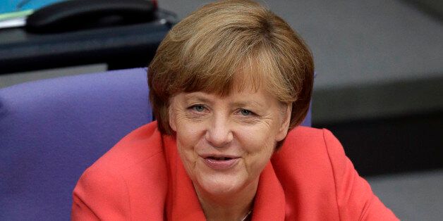 German Chancellor Angela Merkel smiles during a meeting of the German federal parliament, Bundestag, in Berlin, Germany, Friday, July 17, 2015. Merkel is asking German lawmakers to clear the way for negotiations on a new, third bailout package for Greece, arguing that it would be negligent not to try for a deal. (AP Photo/Michael Sohn)