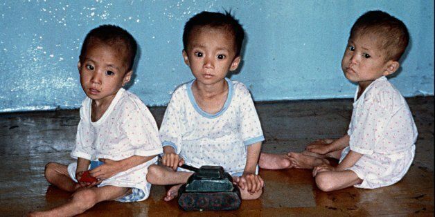 Three severely malnourished North Korean children, between the ages of four and five, sit on the floor of the Kaesong nursery in Wonsan City in Kangwon Province, North Korea on July 12, 1997. A North Korean official recently told relief agency Oxfam that due to malnutrition, about 60,000 children are not expected to survive. (AP Photo/Kathi Zellweger, Caritas)