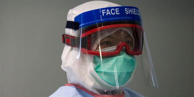 A doctor wearing protective gear takes part in a drill of handling a patient infected with Ebola, in Hong Kong Tuesday, Sept. 2, 2014.  An Ebola outbreak in West Africa has killed more than 1,500 people in Guinea, Liberia, Sierra Leone and Nigeria. The university student is Senegal's first case of the dreaded disease.  (AP Photo/Tyrone Siu, Pool)