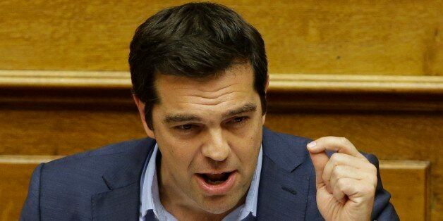 Greece's Prime Minister Alexis Tsipras delivers a speech during an emergency parliament session in Athens, Thursday, July 23, 2015. Greek lawmakers launched a late-night debate Wednesday on further reforms demanded by international creditors in return for a third multi-billion-euro bailout, with attention focusing on government dissenters who have vowed to reject the measures. (AP Photo/Thanassis Stavrakis)