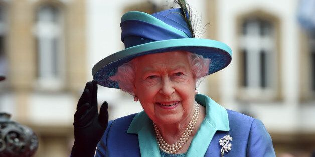 Britain's Queen Elizabeth II waves to the crowd on her way to the city hall in Frankfurt, central Germany, Thursday, June 25, 2015. Queen Elizabeth II and her husband Prince Philip are on an official visit to Germany until Friday, June 26. (Boris Roessler/Pool Photo via AP)