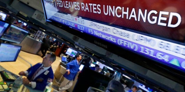 A television screen on the floor of the New York Stock Exchange shows the decision of the Federal Reserve, Wednesday, July 29, 2015. The Federal Reserve appears on track to raise interest rates later this year but is signaling that it wants to see further economic gains and higher inflation before doing so. (AP Photo/Richard Drew)