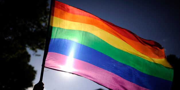 A participants holds a rainbow flag during the gay and lesbian pride parade in the center of Madrid on June 30, 2012. AFP PHOTO/Pedro ARMESTRE        (Photo credit should read PEDRO ARMESTRE/AFP/GettyImages)