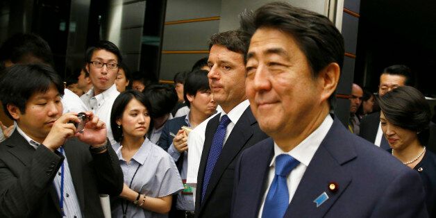 Italian Prime Minister Matteo Renzi, second from right, and his Japanese counterpart Shinzo Abe, right, arrive for a joint news conference following their meeting at Abe's official residence in Tokyo Monday, Aug. 3, 2015. Renzi is on a three-day visit to Japan. (Thomas Peter/Pool Photo via AP)