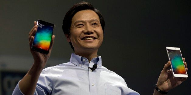Lei Jun, chairman of Chinese smartphone maker Xiaomi, holds up the latest models of the Xiaomi Note at a press event in Beijing, Thursday, Jan. 15, 2015. The Chinese manufacturer on Thursday unveiled a new model that Lei said has processor size and performance comparable to Appleâs iPhone 6 but is thinner and lighter. (AP Photo/Ng Han Guan)