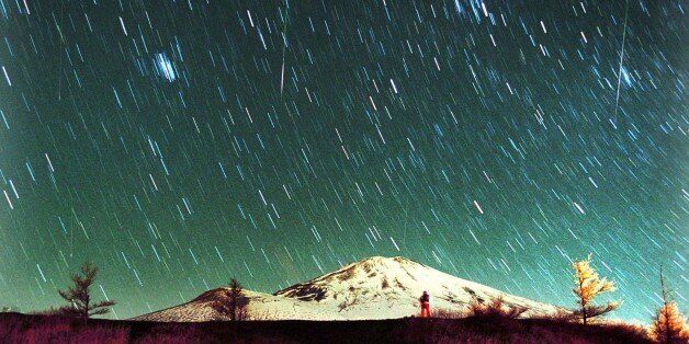 Leonid meteors are seen streaking across the sky over snow-capped Mount Fuji, Japan's highest mountain, early Monday Nov. 19, 2001, in this 7-minute exposure photo. Star gazers braved cold temperatures at the foot of Mount Fuji to observe the shower of Leonid meteors. (AP Photo/Itsuo Inouye)