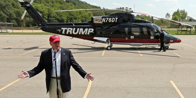 Republican presidential candidate Donald Trump  talks to the media after arriving by helicopter at a nearby ballpark before Trump attended the Iowa State Fair Saturday, Aug. 15, 2015, in Des Moines. (AP Photo/Charlie Riedel)