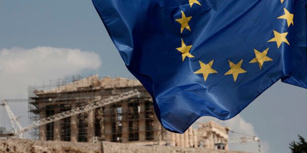 A European Union (EU) flag flutters in front of the temple of the Parthenon in Athens, Greece, Saturday, Aug. 15, 2015. Finance ministers of the 19-nation euro single currency group on Friday approved the first 26 billion euros ($29 billion) of a vast new bailout package to help rebuild Greece's shattered economy.  (AP Photo/Yorgos Karahalis)