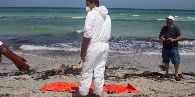 Workers for the Red Crescent pull dead migrants from the water and place them in orange-and-black body bags laid out on the waterfront in Zuwara, about 105 kilometers (65 miles) west of Tripoli, Libya, Friday, Aug. 28, 2015. Two ships went down Thursday off the western Libyan city, where Hussein Asheini of the Red Crescent said over 100 bodies had been recovered. About 100 people were rescued, according to the Office of the U.N. High Commissioner for Refugees, with at least 100 more believed to