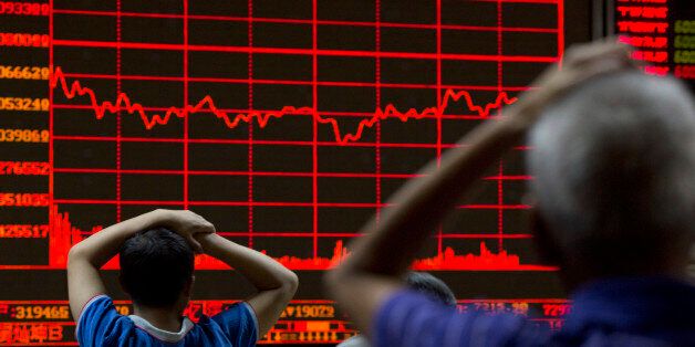 Investors monitor a display showing the Shanghai Composite Index at a brokerage in Beijing, Monday, Aug. 31, 2015. Asian stocks fell Monday after a U.S. Federal Reserve official suggested a September interest rate hike still was possible and Japanese factory activity weakened. (AP Photo/Ng Han Guan)