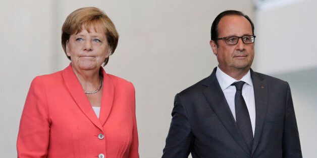 German Chancellor Angela Merkel, right, and French President Francois Hollande arrive for a press statement about the European migrant crisis prior to a meeting at the chancellery  in Berlin, Monday, Aug. 24, 2015. (AP Photo/Markus Schreiber).