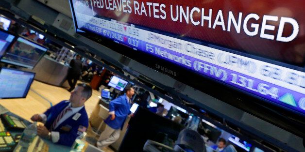 A television screen on the floor of the New York Stock Exchange shows the decision of the Federal Reserve, Wednesday, July 29, 2015. The Federal Reserve appears on track to raise interest rates later this year but is signaling that it wants to see further economic gains and higher inflation before doing so. (AP Photo/Richard Drew)