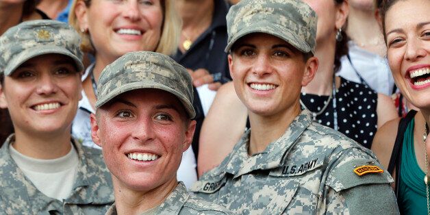 U.S. Army First Lt. Shaye Haver, center, and Capt. Kristen Griest, right, pose for photos with other female West Point alumni after an Army Ranger school graduation ceremony, Friday, Aug. 21, 2015, at Fort Benning, Ga. Haver and Griest became the first female graduates of the Army's rigorous Ranger School, putting a spotlight on the debate over women in combat.   (AP Photo/John Bazemore)