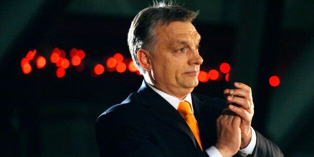 Hungarian Prime Minister Viktor Orban, leader of the ruling center-right Fidesz party applauds prior to his victory speech after the parliamentary elections in downtown Budapest, Hungary, late Sunday, April 6, 2014. (AP Photo/MTI, Laszlo Beliczay)