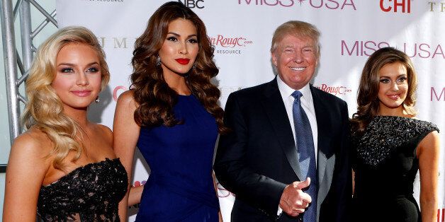 (left to right) Miss Teen USA 2013 Cassidy Wolf, Miss Universe 2013 Gabriela Isler, Donald Trump, and Miss USA 2013 Erin Brady pose during a red carpet event before the Miss USA 2014 pageant in Baton Rouge, La., Sunday, June 8, 2014. (AP Photo/Jonathan Bachman)
