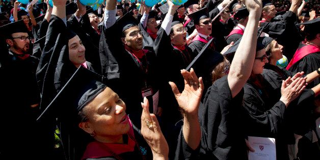 ill tGraduates of Harvard School of Government, including Susan Reed-Allen, of El Dorado, Ark., below left, wave inflatable globes as their school's degrees are conferred during Harvard University commencement exercises, in Cambridge, Mass., Thursday, May 24, 2012. (AP Photo/Steven Senne)