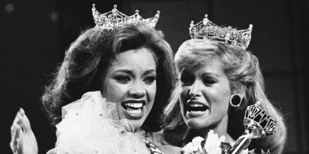 Vanessa Williams, the new Miss America, left, is shown as she is crowned, Saturday, Sept. 17, 1983 in Atlantic City, New Jersey, by the outgoing Miss America, Debra Maffett. (AP Photo)