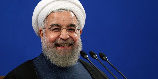 FILE - In this Aug. 29, 2015 file photo, Iran's President Hassan Rouhani smiles during his press conference in Tehran, Iran. Rouhani said Tuesday, Sept. 8, 2015 that his country is ready to hold talks with the United States and Saudi Arabia on ways to resolve the Syrian civil war, providing such negotiations can secure peace and democracy in conflict-torn Syria. Rouhani's remarks came during a press conference on Tuesday with visiting Austrian counterpart Heinz Fischer. (AP Photo/Ebrahim Noroozi