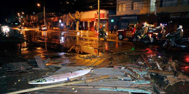 Police patrol a debris strewn street in Valparaiso, Chile, after a tsunami, caused by an earthquake hit the area, Wednesday, Sept. 16, 2015. A magnitude-8.3 earthquake hit off Chile's northern coast, causing buildings to sway in Santiago and other cities and sending people running into the streets. Authorities reported one death in a town north of the capital.(Pablo Ovalle Isasmendi/AGENCIA UNO via AP) CHILE OUT - NO USAR EN CHILE