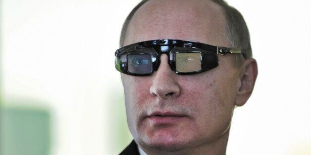 Russian President Vladimir Putin wears special glasses as he visits a research facility of the St. Petersburg State University in St. Petersburg, Russia, on Monday, Jan. 26, 2015. In televised comments after a meeting with students in St. Petersburg, President Vladimir Putin said that Ukraineâs army was at fault for the increase in violence and accused it of using civilians as âcannon fodderâ in the conflict. â(Ukraineâs army) is not even an army, itâs a foreign leg