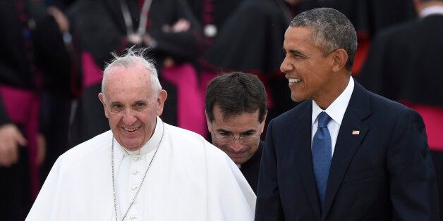 Pope Francis, left, walks with President Barack Obama, right, after arriving at Andrews Air Force Base, Md., Tuesday, Sept. 22, 2015. The Pope is spending three days in Washington before heading to New York and Philadelphia. This is the Pope's first visit to the United States. (AP Photo/Susan Walsh)
