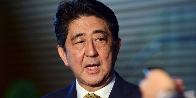 Japanese Prime Minister SHinzo Abe speaks to reporters at his official residence in Tokyo Tuesday, Sept. 8, 2015. Abe has won a new term as president of the ruling Liberal Democratic Party after facing no opposition for the job. (Yoshikazu Tsuno/Pool Photo via AP)