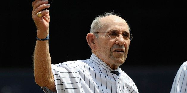 Former New York Yankees catcher Yogi Berra tips his cap during Old Timers' Day ceremonies Sunday, June 26, 2011 at Yankee Stadium in New York. (AP Photo/Bill Kostroun)