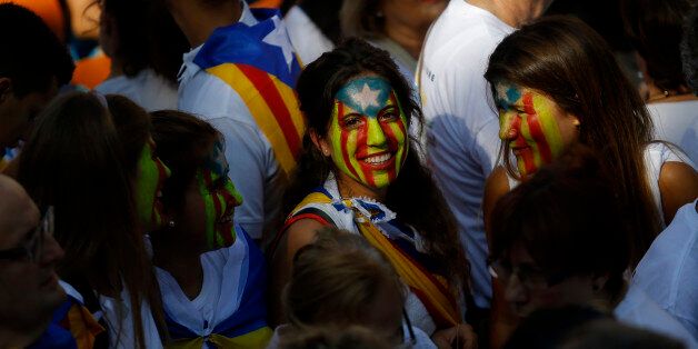 Young girls with their face painted with a pro-independence Catalan flag, known as the Estelada flag, gather with others during a rally calling for the independence of Catalonia, in Barcelona, Spain, Friday, Sept. 11, 2015. Advocates of independence for Spain's northeastern region of Catalonia on Friday launched their campaign to try to elect a majority of secessionists in regional parliamentary elections on Sept. 27. (AP Photo/Francisco Seco)