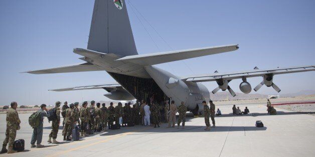 In this Tuesday, Aug. 18, 2015 photo, Afghan National Army soldiers line up to get into a C-130 Hercules, at Kandahar Air Base, in Kandahar, Afghanistan. A series of airports, built by NATO to fight the Taliban, are being handed over to the Afghan government in a civil aviation upgrade that optimists hope will fuel not only regional trade but even tourism. The eight airfields, worth an estimated $2 billion, are scattered around a landlocked and mountainous land whose lack of rail transport or de