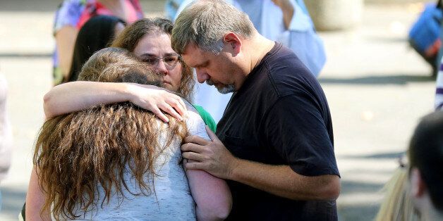 Friends and family are reunited with students at the local fairgrounds after a deadly shooting at Umpqua Community College, in Roseburg, Ore., Thursday, Oct. 1, 2015.  (AP Photo/Ryan Kang)