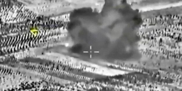 This image made from footage taken from Russian Defense Ministry official website on Friday, Oct. 2, 2015, shows another attack made from a fighter jet in Syria. The Russian Defense Ministry says its aircraft have carried out 18 sorties in Syria in the past 24 hours, including 10 overnight in which seven sites were bombed. The annotations on the image were made by the source and indicate the center of the target, and its direction, yellow. (AP Photo/ Russian Defense Ministry Press Service)
