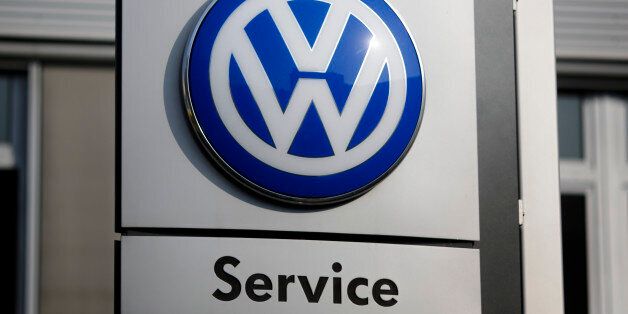 The VW sign of Germany's car company Volkswagen is displayed at the building of a compsny's retailer in, Berlin, Germany, Monday, Oct. 5, 2015. (AP Photo/Markus Schreiber)