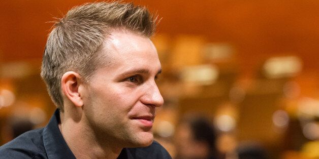 Austria's Max Schrems listens to a ruling at the European Court of Justice in Luxembourg on Tuesday, Oct. 6, 2015. Europe's highest court has ruled in favor of an Austrian law student who claims a trans-Atlantic data protection agreement doesn't adequately protect consumers. (Geert Vanden Wijngaert)