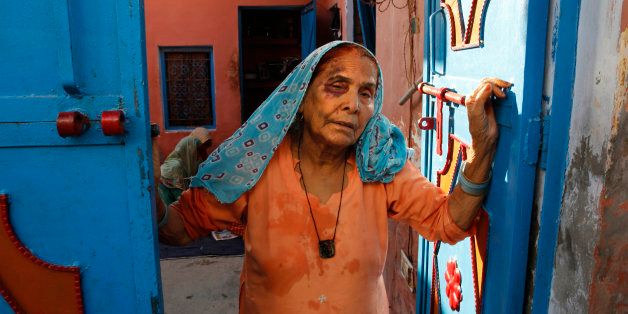 A bruised Asgari Begum, mother of 52-year-old Muslim farmer Mohammad Akhlaq, stands by the entrance of her home in Bisara, a village about 45 kilometers (25 miles) southeast of the Indian capital of New Delhi, Wednesday, Sept. 30, 2015. Indian police arrested eight people and were searching Wednesday for two more after villagers allegedly beat Akhlaq to death and severely injured his son upon hearing rumors that the family was eating beef, a taboo for many among Indiaâs majority Hindu popul