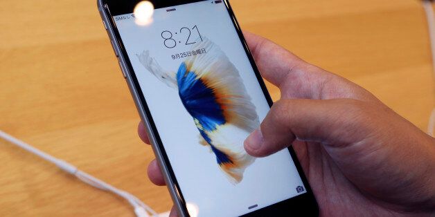 A customer tries new iPhone 6s on display at an Apple store in Tokyo Friday, Sept. 25, 2015. Apple is counting on sales of the new iPhones to maintain its position as one of the most profitable, and valuable, companies in the world. (AP Photo/Koji Sasahara)